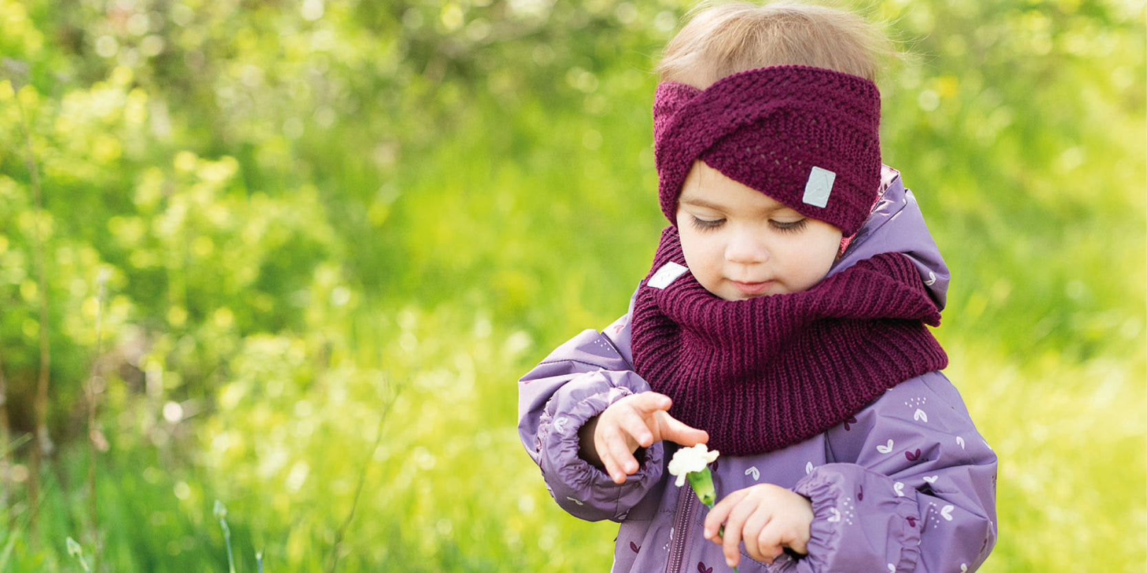 Prtite fille jouant dehors avec un manteau perlimpinpin